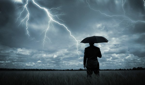 businessman in a storm, man with an umbrella