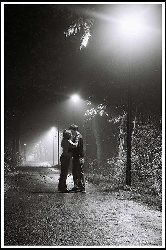 first kiss, black and white of teens kissing, kissing in the woods